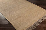 Close-up of the tan and medium brown Partoun Area Rug showing its hand woven texture and fringe detail. Corner