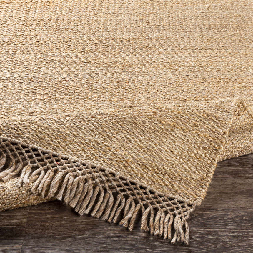 Close-up of the tan and medium brown Partoun Area Rug showing its hand-woven texture and fringed edge. Fold