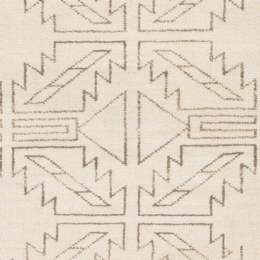 Close-up of the hand-knotted Pawhuska Area Rug. Charcoal and peach geometric shapes on a cream wool background. Swatch