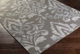 Close-up of the Pearsonville Area Carpet. Gray wool rug with a large, light gray traditional damask pattern. Corner