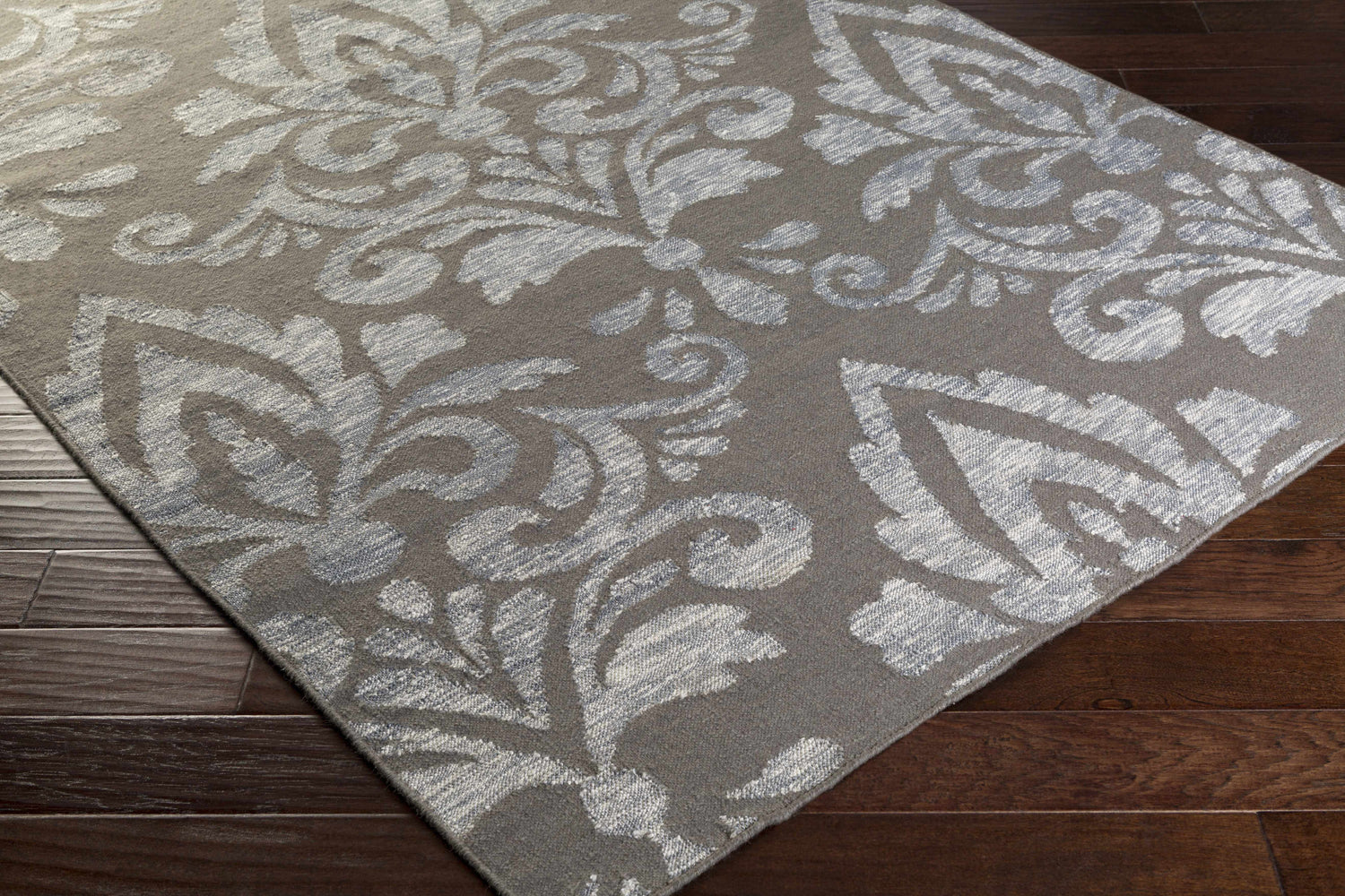 Close-up of the Pearsonville Area Carpet. Gray wool rug with a large, light gray traditional damask pattern. Corner