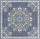 Close-up of the Penland Area Rug, featuring a navy, teal, and taupe floral medallion pattern and decorative border. Design-Square-73