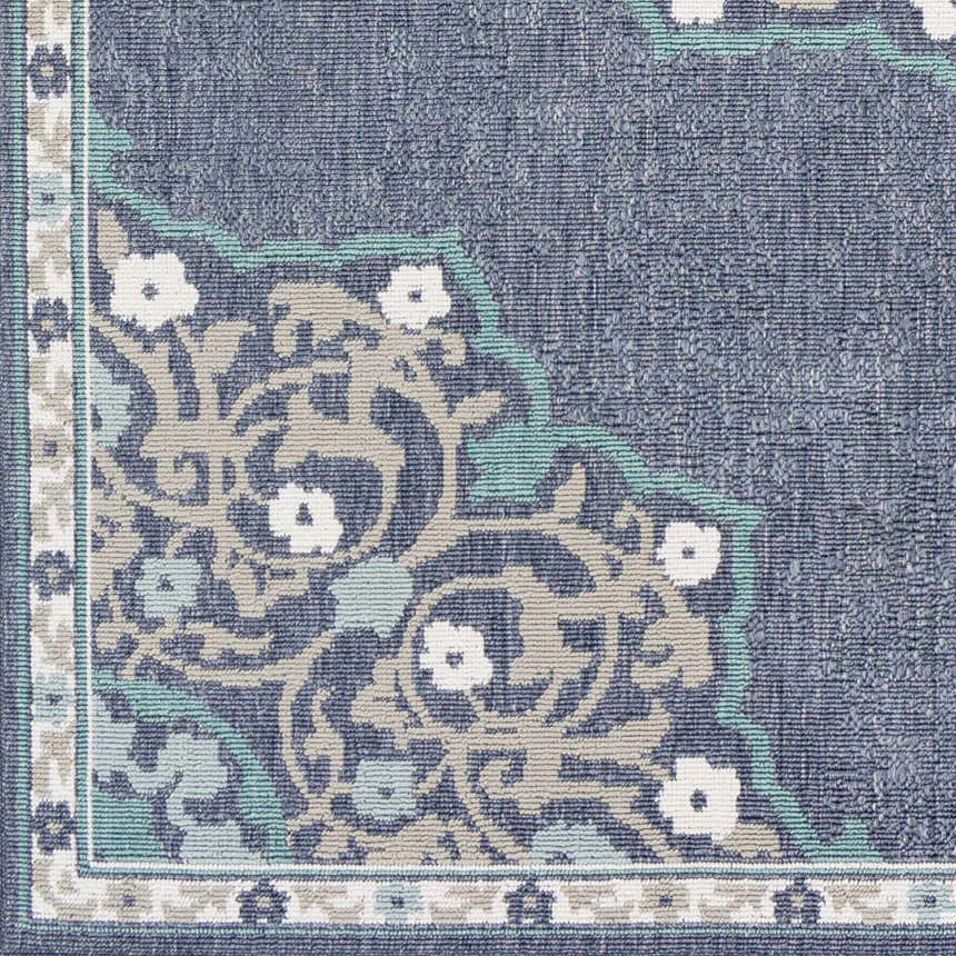 Close up of the Penland Area Rug showing navy, pale blue, taupe, and white floral and vine pattern. Swatch