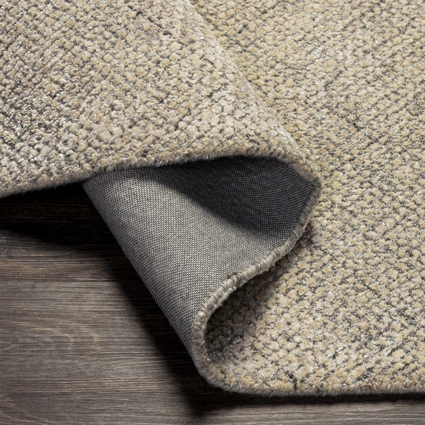 Close-up of the Phalaborwa Area Rug, showing its gray, light beige, and tan textured wool and viscose weave. Fold