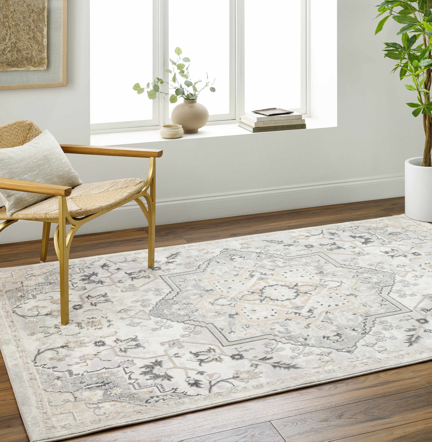 Light gray Phyre Area Rug in a bright living room with wood floors, a woven chair, and a large window. Roomscene-Rectangle