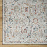 Close-up of Piera Washable Area Rug. Ash, light gray, silver tones, traditional floral pattern, machine woven texture. Corner