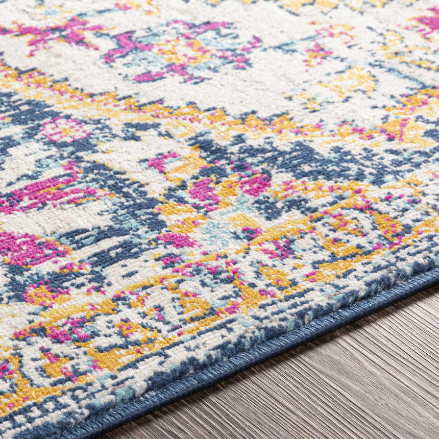 Close-up of the Pimperne Traditional Medallion Area Rug, featuring burnt orange, fuchsia, and navy on a light beige background. Texture