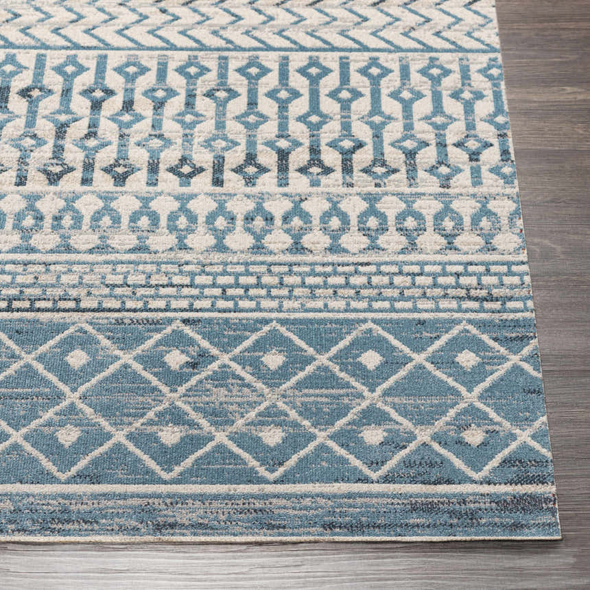 Close up of the Pinamopoan Washable Area Rug in blue, gray, and beige with a contemporary geometric pattern. Front