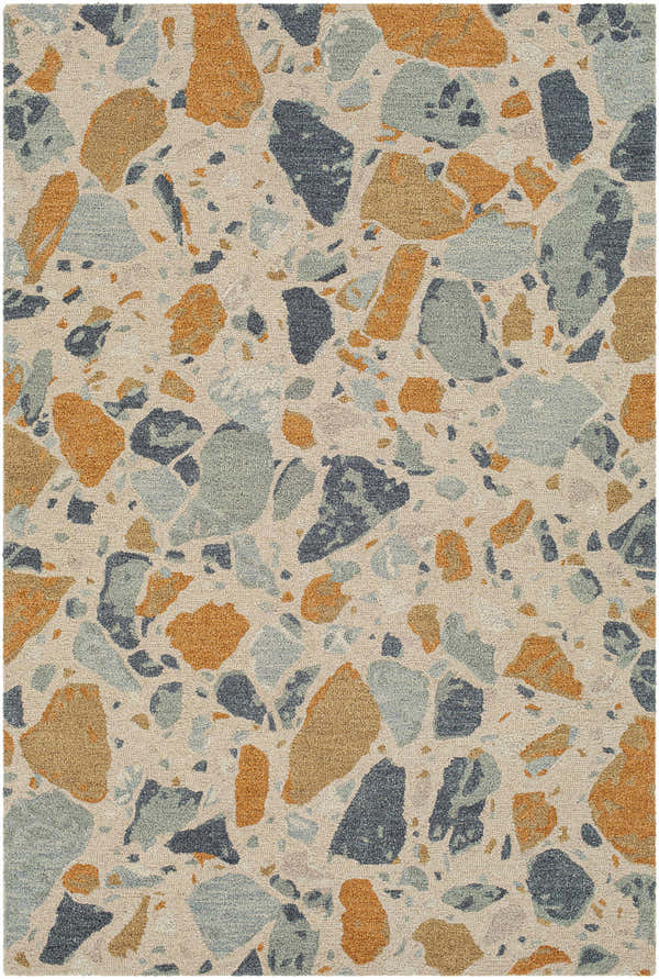 Close-up of the Panabingan Area Rug; a hand-tufted wool rug with a terrazzo-inspired pattern in brick red, dark blue, beige, and sage. Design-Rectangle-576