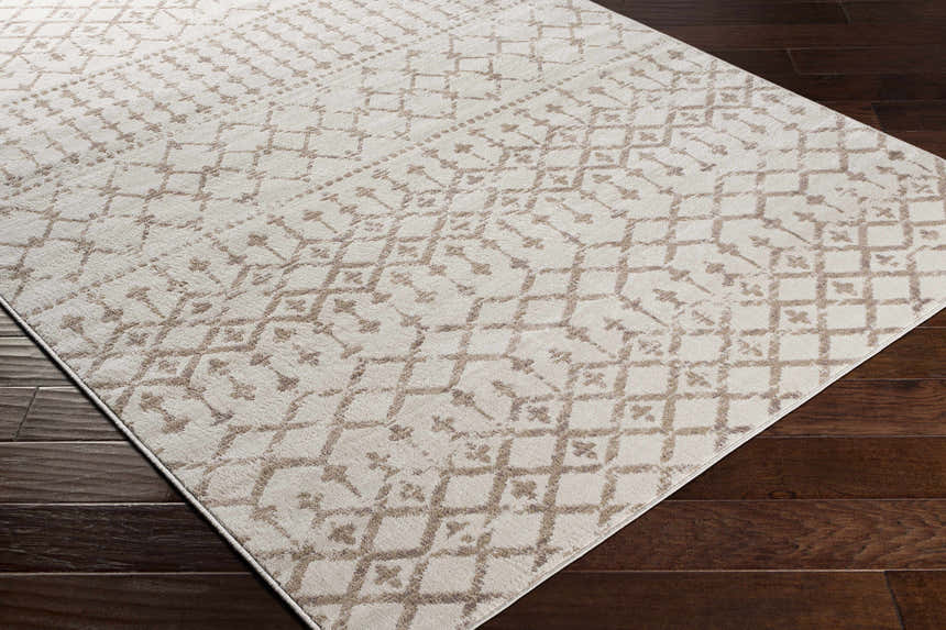 Close-up of the Pineview Area Carpet showing a tan geometric pattern on an ivory base, machine woven texture. Corner