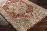 Close-up of the Powassan Area Rug showing brick red, charcoal, light beige, and teal colors in a traditional pattern. Corner