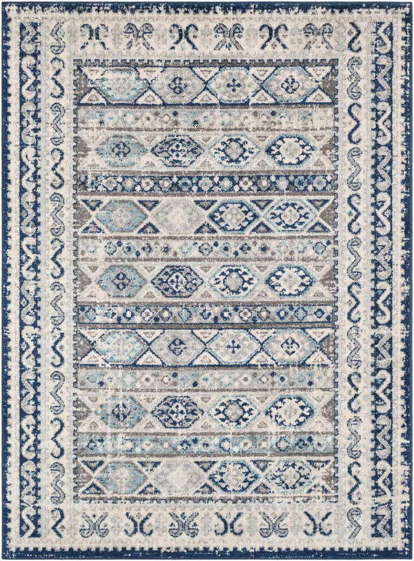 Close-up of the Purdys Area Rug. Bohemian style rug with aqua, charcoal, cream, and blue geometric patterns. Design-Rectangle-5373
