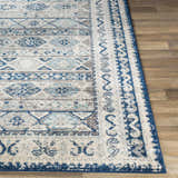 Close-up of the Purdys Area Rug showing its bohemian-style pattern in aqua, charcoal, cream, and blue tones. Front