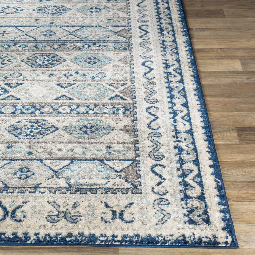 Close-up of the Purdys Area Rug showing its bohemian-style pattern in aqua, charcoal, cream, and blue tones. Front