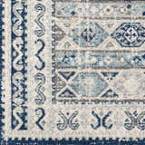 Close-up of the Purdys Area Rug featuring a geometric, bohemian design in aqua, charcoal, and cream. Swatch