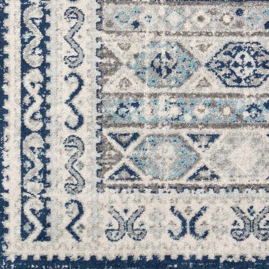 Close-up of the Purdys Area Rug featuring a geometric, bohemian design in aqua, charcoal, and cream. Swatch