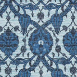 Close-up of the Premier Area Rug - Clearance, showcasing its hand-woven cotton texture and blue floral pattern. Swatch
