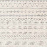 Close-up of Parmelia Area Rug showing off-white base and charcoal geometric tribal-inspired pattern. Swatch