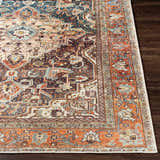 Close-up of the Portlaw Washable Area Rug. Bohemian style rug with blue, brick red, and beige oriental pattern. Front