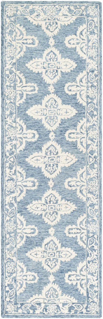 Close-up of the hand tufted Passaic Wool Rug. Features a traditional, bohemian pattern in blue and light beige. Design-Runner-268