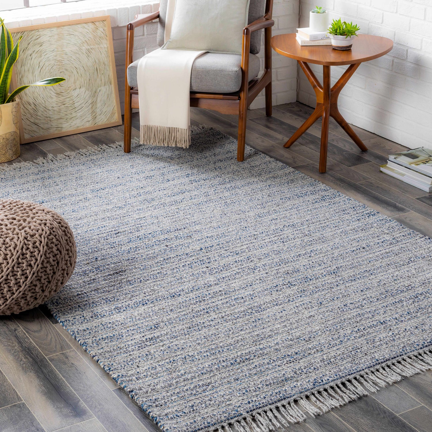 Living room scene with a blue and cream Potterspury Area Rug, gray chair, and wooden accents. Contemporary style. Roomscene-Rectangle