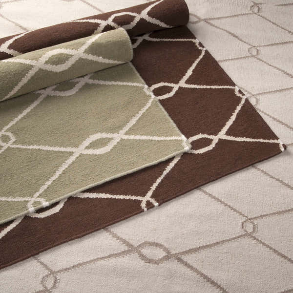 Close-up of Pudsey Area Rug showing light beige, olive, and brown color variations with a geometric trellis pattern. Styleshot