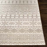 Close-up of the Pumwani Area Carpet. Cream wool rug with gray geometric, diamond, and tribal-inspired patterns. Front