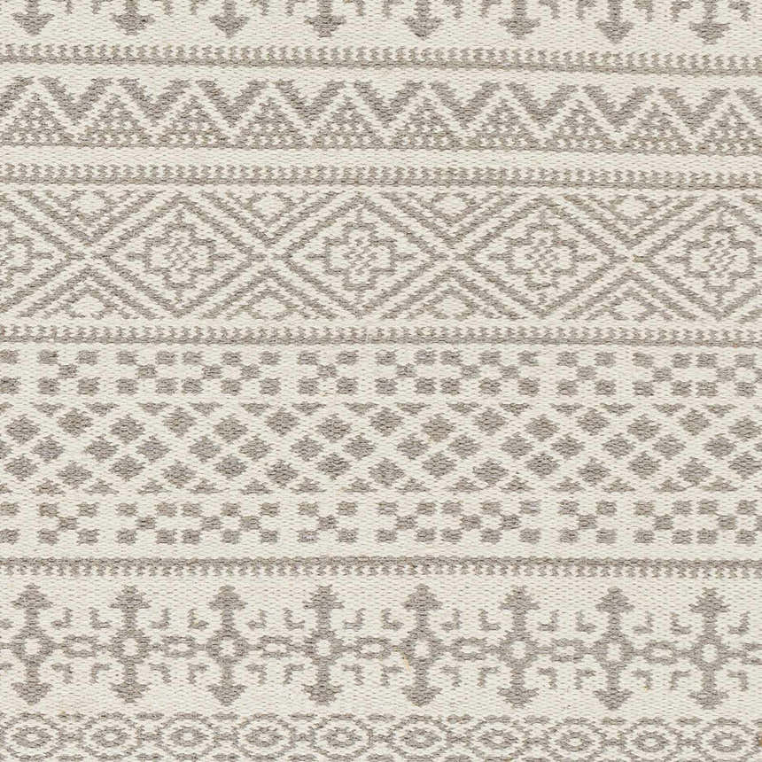 Close-up of Pumwani Area Carpet showing hand woven wool texture and cream and gray geometric, bohemian pattern. Swatch