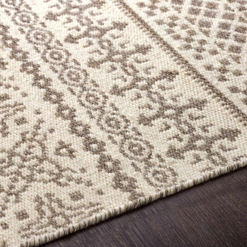 Close-up of the Pumwani Area Carpet. Hand-woven wool rug with cream and gray bohemian pattern. Farmhouse style. Texture