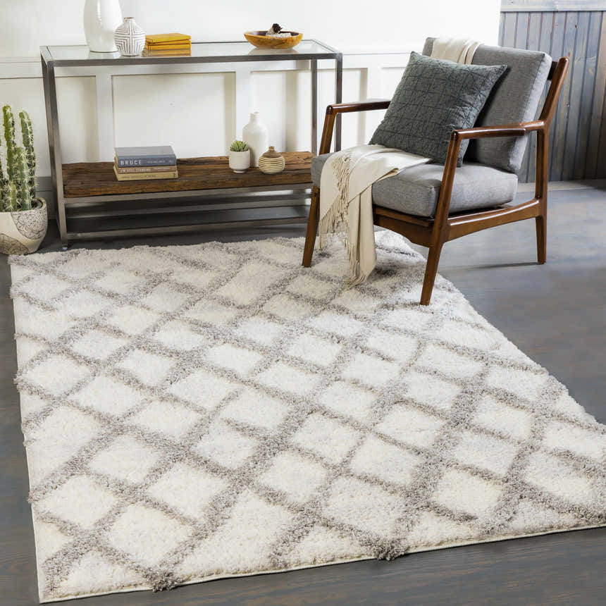 Living room scene with gray chair and white Putat Area Rug with gray diamond pattern. Roomscene-Rectangle