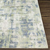 Close up of the Pyle Area Rug showing its beige, blue, and sage contemporary design and hand-knotted texture. Front