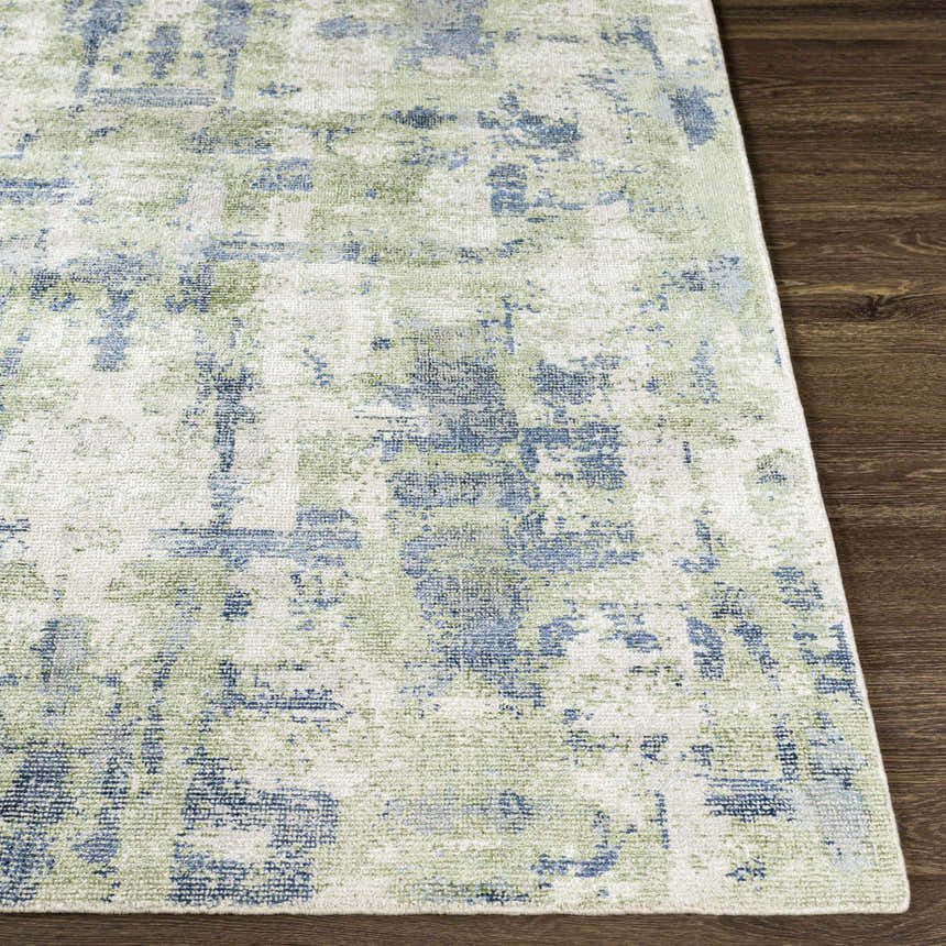 Close up of the Pyle Area Rug showing its beige, blue, and sage contemporary design and hand-knotted texture. Front