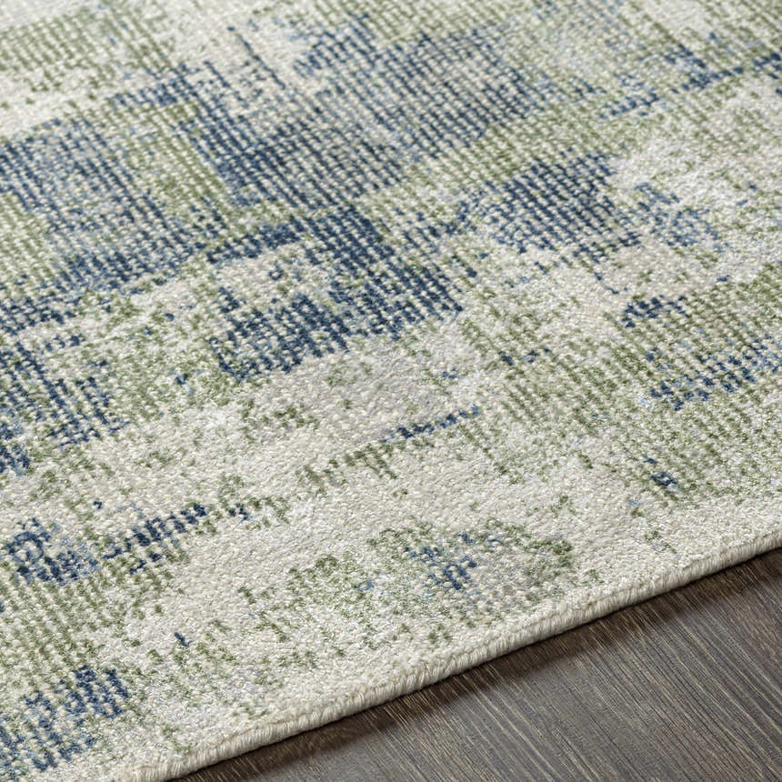 Close-up of Pyle Area Rug showing beige, blue, and sage contemporary pattern and hand-knotted texture. Texture