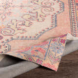 Close up of the Queenscliff Rug, a hand-tufted rug with a bohemian, Persian-inspired design in peach, beige, and blue tones. Fold