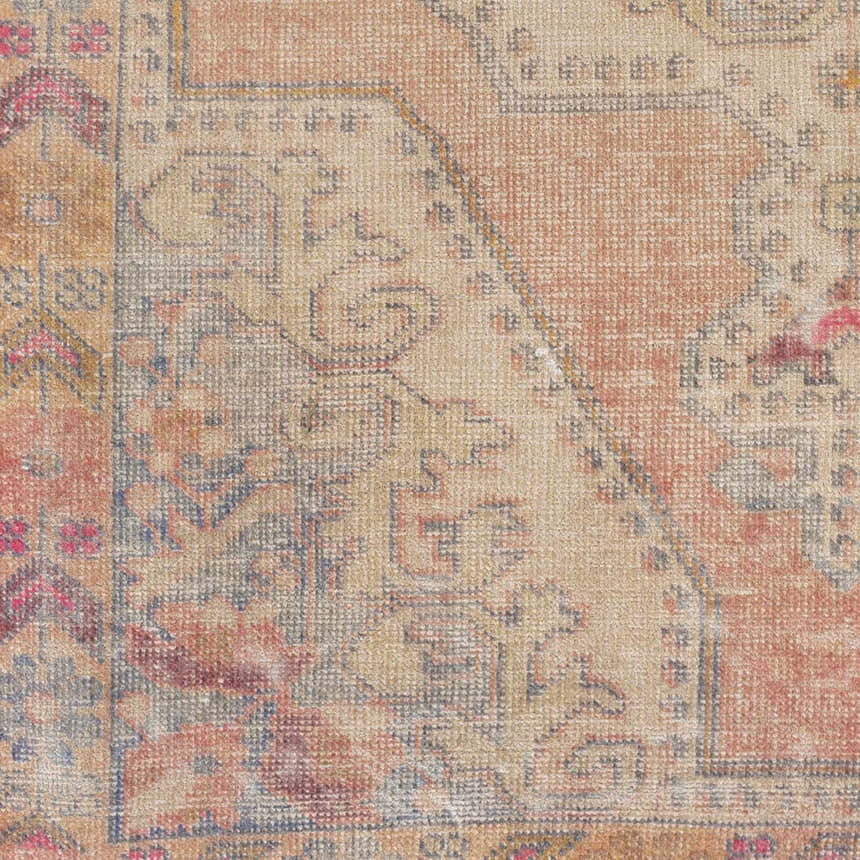 Close-up of the Queenscliff Rug showing its traditional Persian-style pattern and warm tones of beige, orange, and red. Swatch