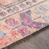Close-up of the Queenscliff Rug showing its hand-tufted texture and bohemian-inspired pink, gray, and beige pattern. Texture
