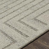 Close up of the Queenton Area Rug showing charcoal geometric lines on light gray 100% wool texture. Texture