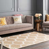 Living room scene with beige sofa, gold accents, and the Quicksand Area Rug in a neutral geometric pattern. Roomscene-Rectangle