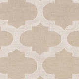 Close-up of the Quicksand Area Rug showing a neutral quatrefoil pattern and hand-tufted wool texture. Swatch