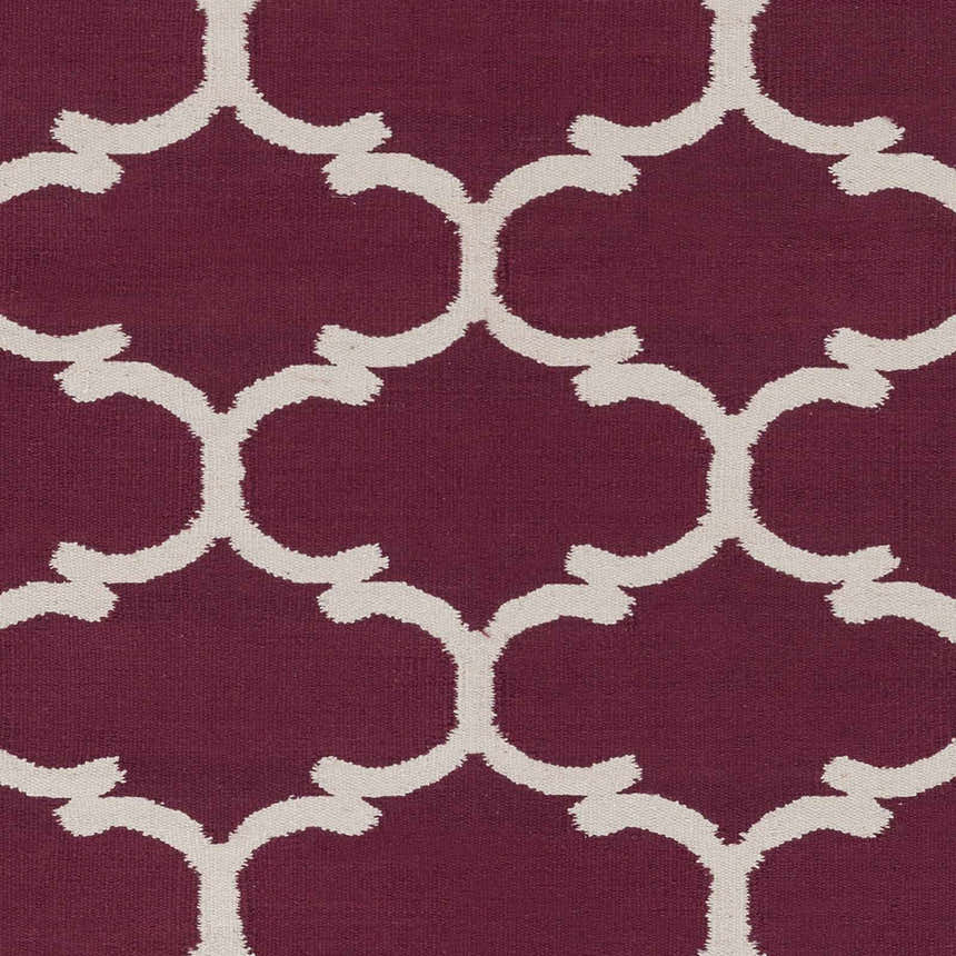 Close-up of Racine Area Carpet. Dark purple rug with an ivory quatrefoil pattern. Hand woven cotton rug texture. Swatch