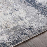 Close-up of the Rainworth Modern Slate Luxe Rug showing its charcoal, gray, and blue abstract pattern and soft texture. Texture