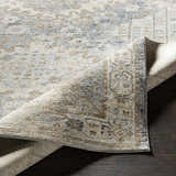 Close up of the Randalia Area Rug showing the traditional pattern, gray, ivory, and brown colors. Fold