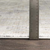 Close-up of Randalia rug showing pile height with ruler. Colors: ivory, gray, and tan. Bohemian style. Pile
