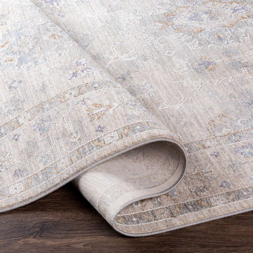 Close-up of Rochedale Area Rug showing cream, lavender, olive, and pale blue hues and traditional pattern. Fold