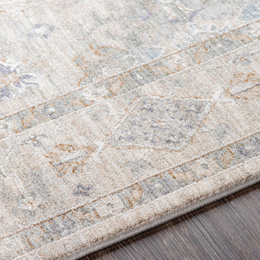 Close up of the Rochedale Area Rug showing cream, lavender, olive, and pale blue traditional pattern and soft texture. Texture