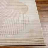 Close-up of the Zeke Geometric Nutmeg Rug showing its linear and circular pattern in brown and cream on wood flooring. Front