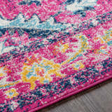Close up of the Reedham Magenta Area Rug showing fuchsia, blue, yellow, and cream colors. Texture