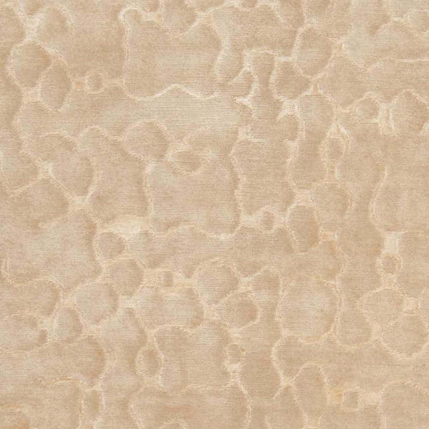 Close-up of the Renault Area Carpet. Beige and mustard tones with a subtle, organic pattern. Hand-knotted texture. Swatch