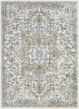 Close-up of the Reubens Area Rug, a machine-woven rug with a traditional floral pattern in ivory, gold, and blue. Design-Rectangle-5373