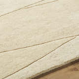 Close-up of the Robin Modern Wool Rug showing its cream color, subtle carved pattern, and hand-tufted texture. Texture